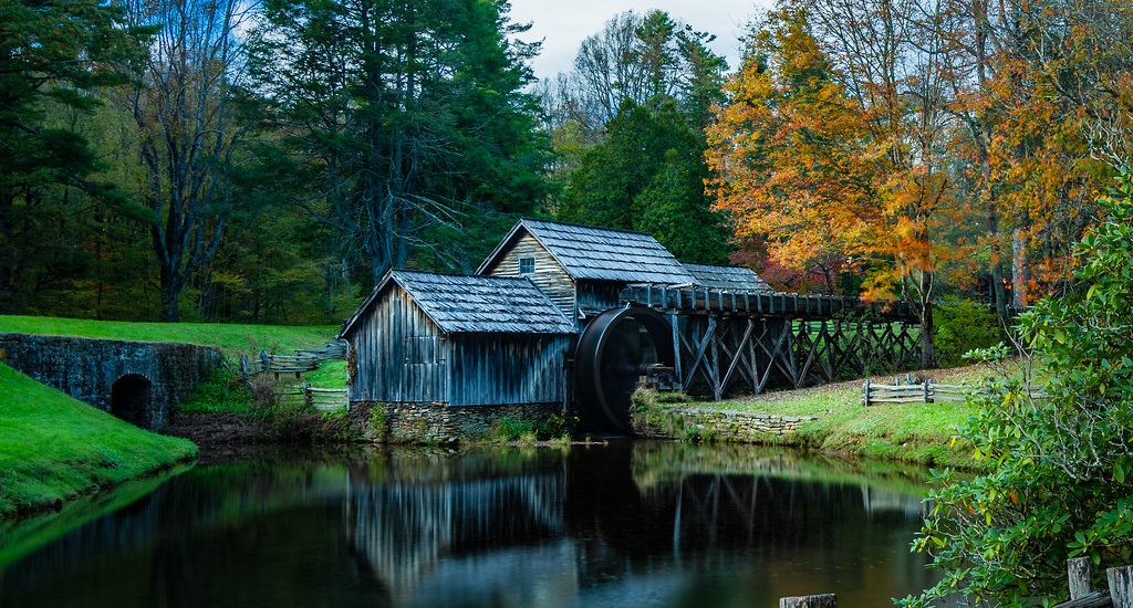 Mabry Mill on the Blue Ridge Parkway reflected in its pond among autumn trees